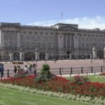 View of Buckingham Palace with lush gardens on a sunny day in London.